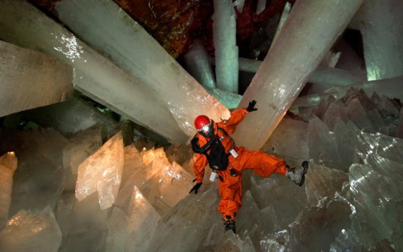 Researcher in protective gear among the crystals.